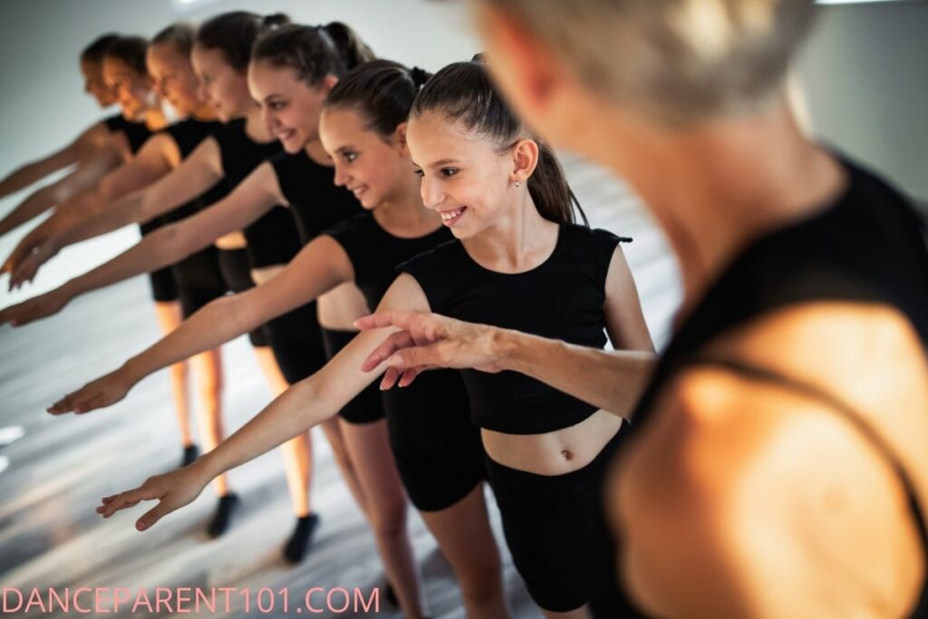Dancers in a line with teacher pointing