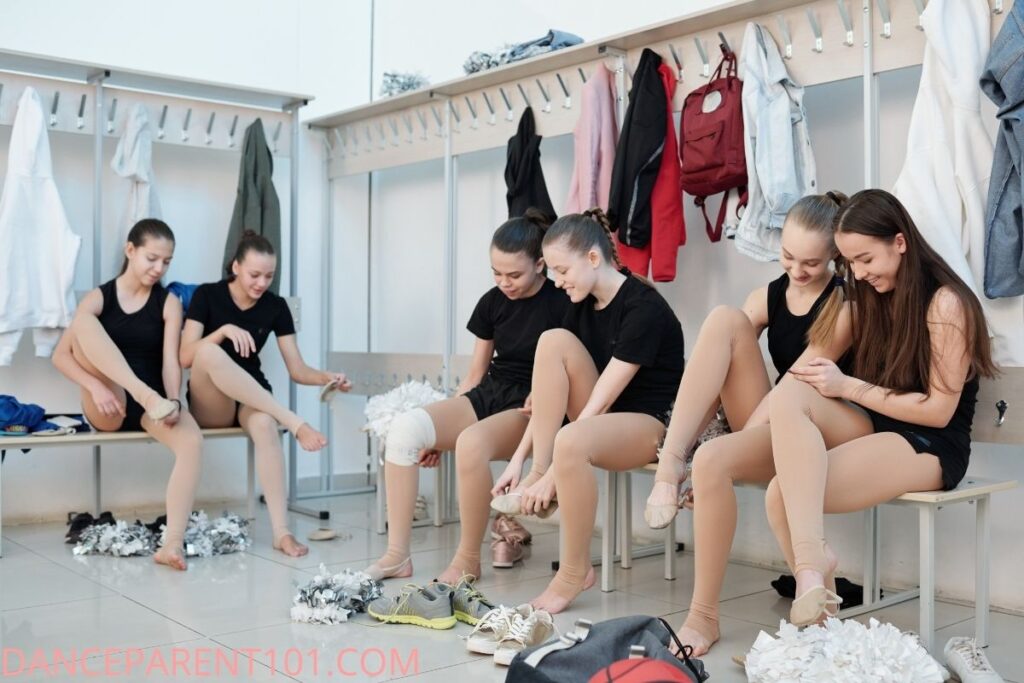 6 girls in locker room getting ready for dance class