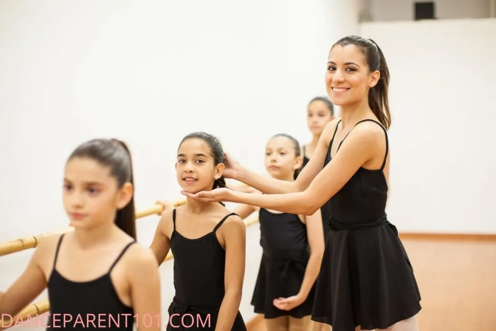 the teacher with the dancers wearing black dress