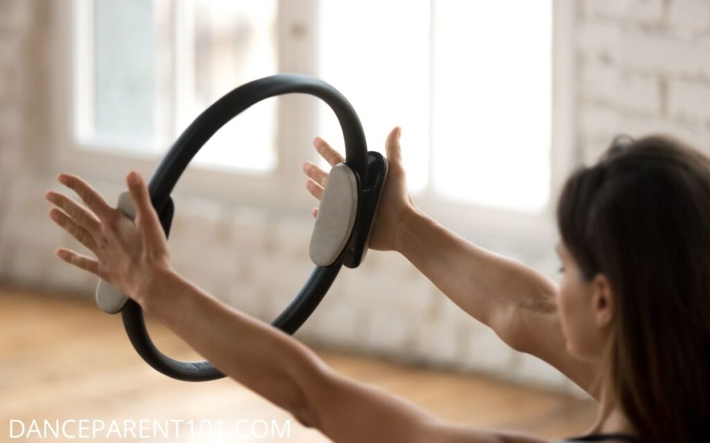 Woman using a pilates magic circle to train