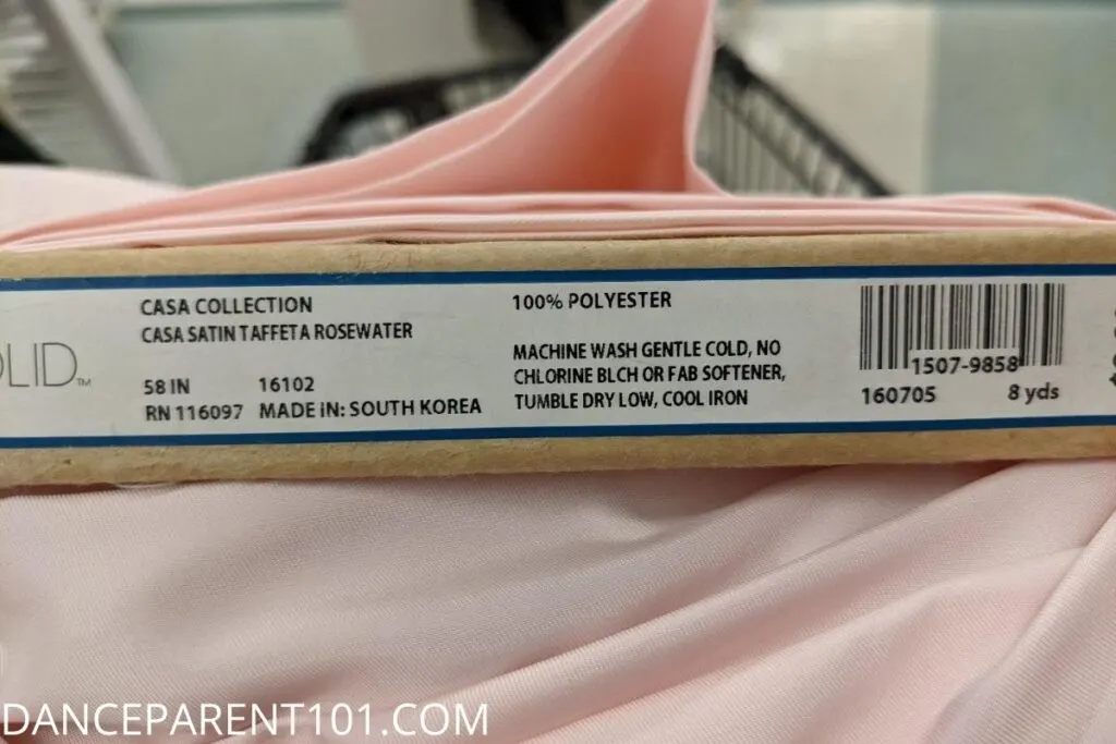 This fabric is 58" wide, but is considered 60" wide for yardage needs. Note that the care instructions are shown as well.