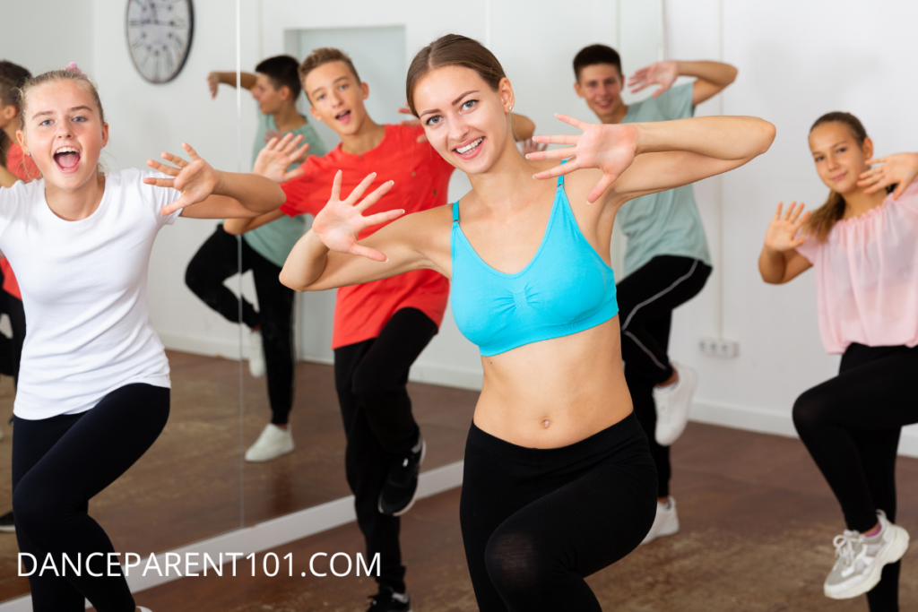 Image of a group of tween dancers hitting a pose in dance class
