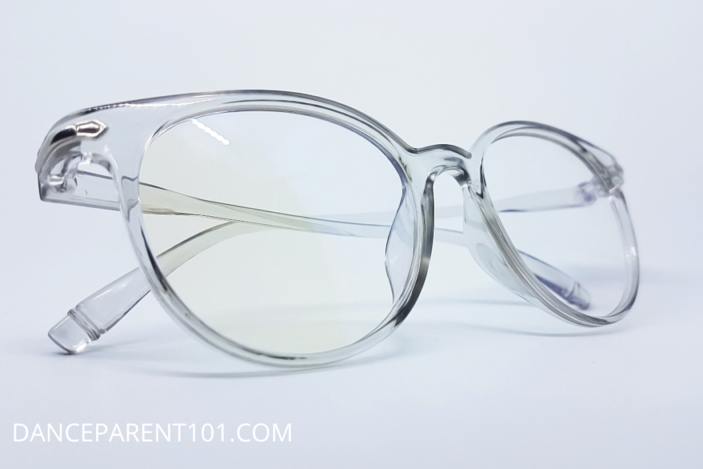 An image of a pair of clear framed glasses folded on a white background