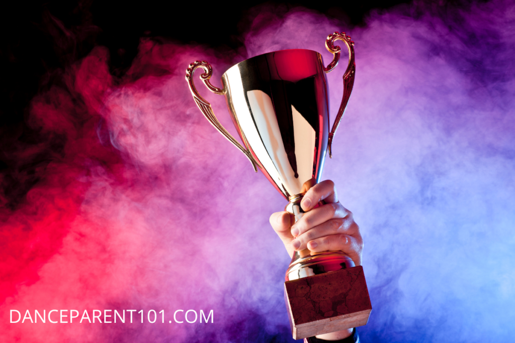 Image of a gold cup trophy on a blue, red, and purple hazy background