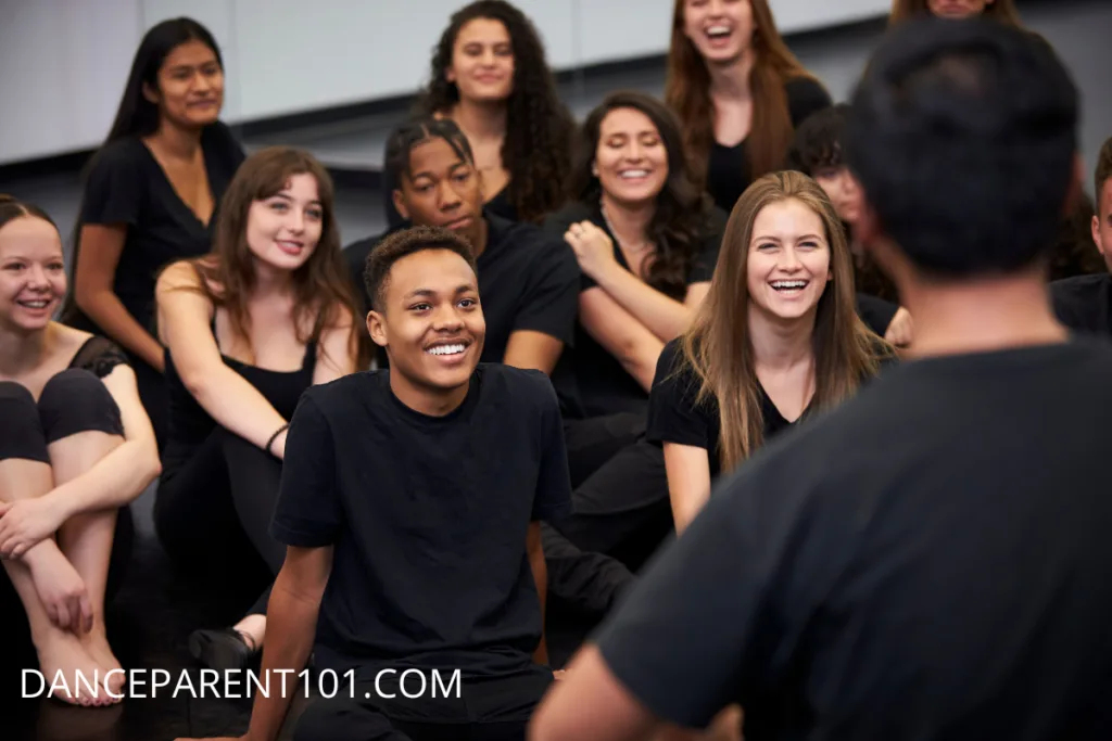 Image of a group of older teenagers in black clothing facing an instructor
